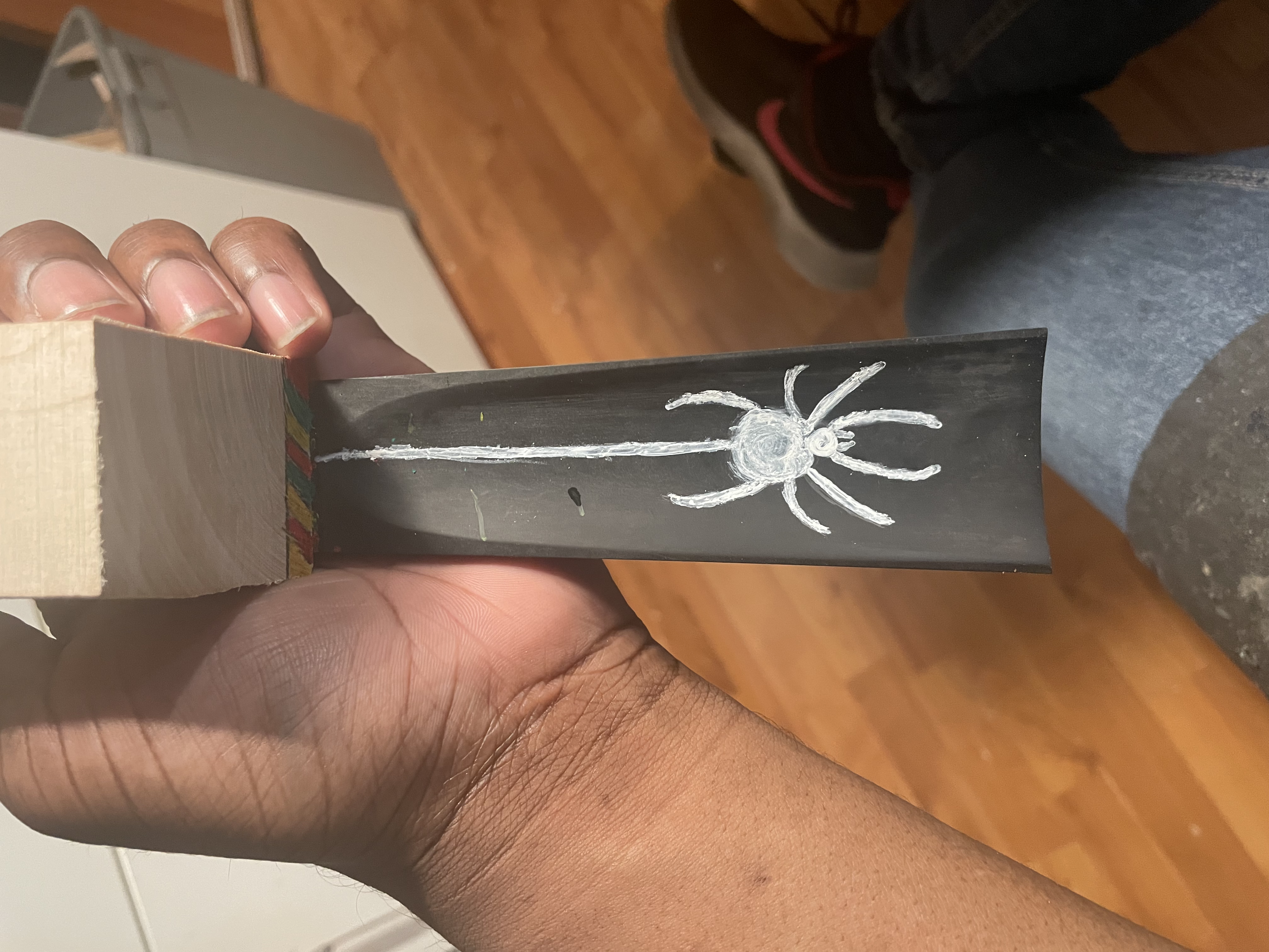 The underside of my fingerboard, an all white spider.